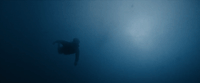 a person in a wet suit swimming in the ocean