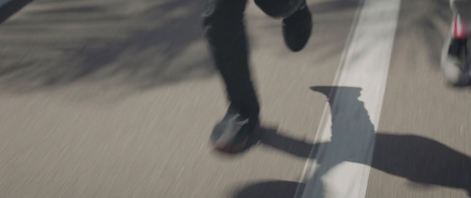 a person walking down a street with a skateboard