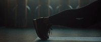 a person's foot on a platform in the dark