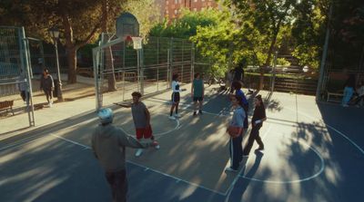 a group of people standing on top of a basketball court