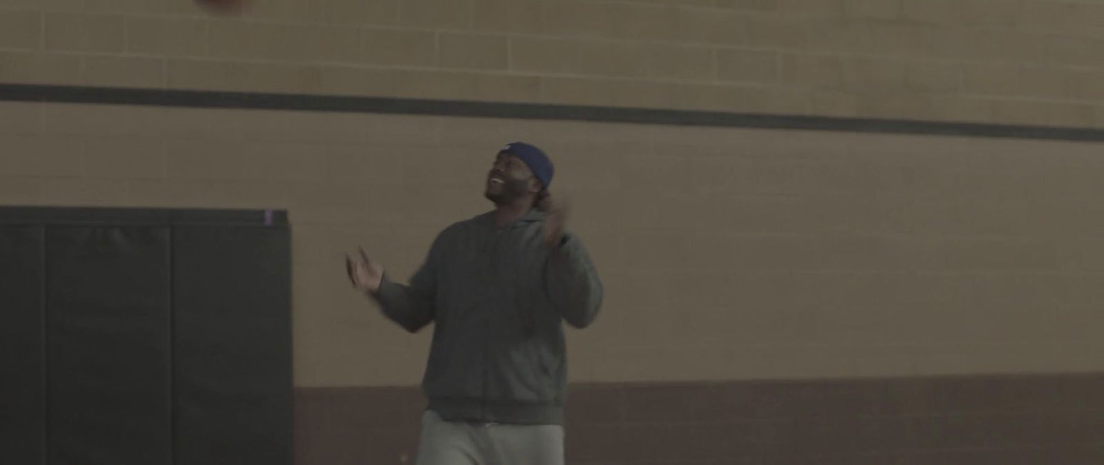 a man standing in front of a basketball hoop