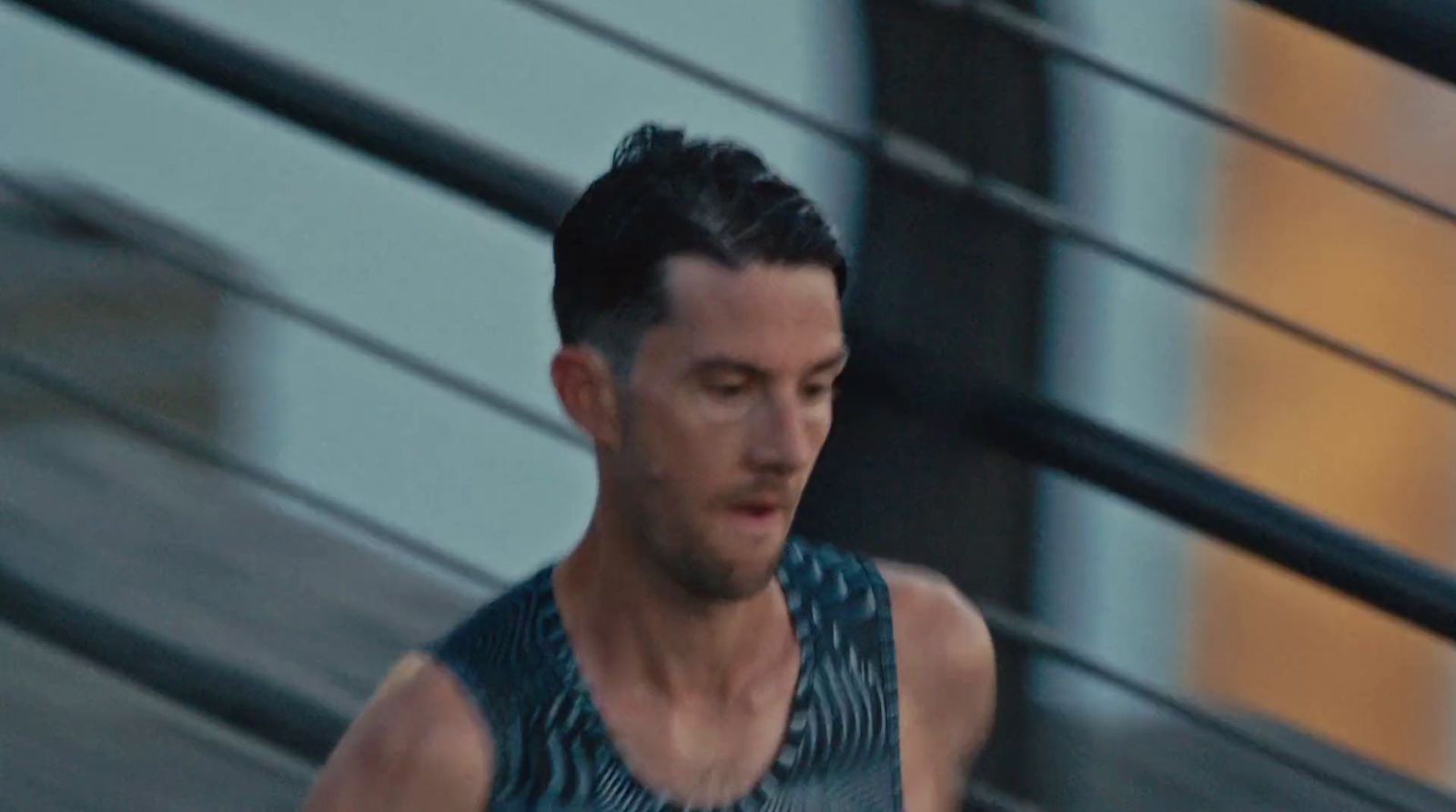 a man in a tank top running down a street