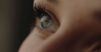 a close up of a woman's blue eye