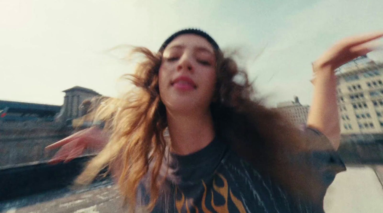 a woman with her hair blowing in the wind