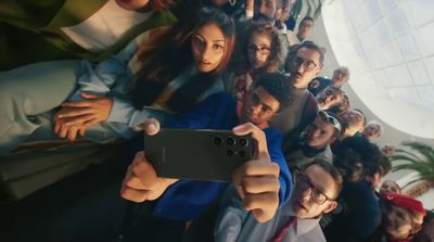 a group of people are taking a selfie with a cell phone