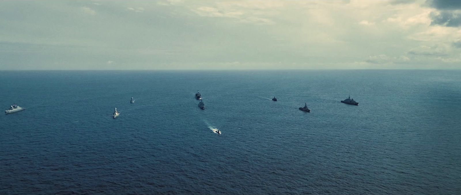 a group of ships in the middle of the ocean