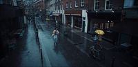 a man walking down a street holding an umbrella