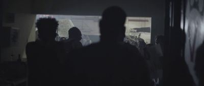 a group of people standing in a dark room