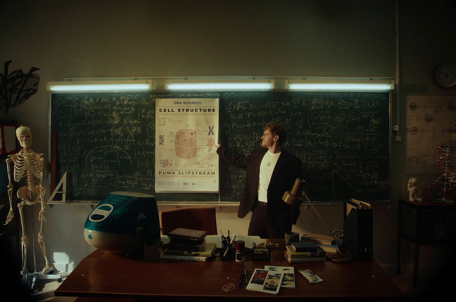 a man standing in front of a blackboard in a room