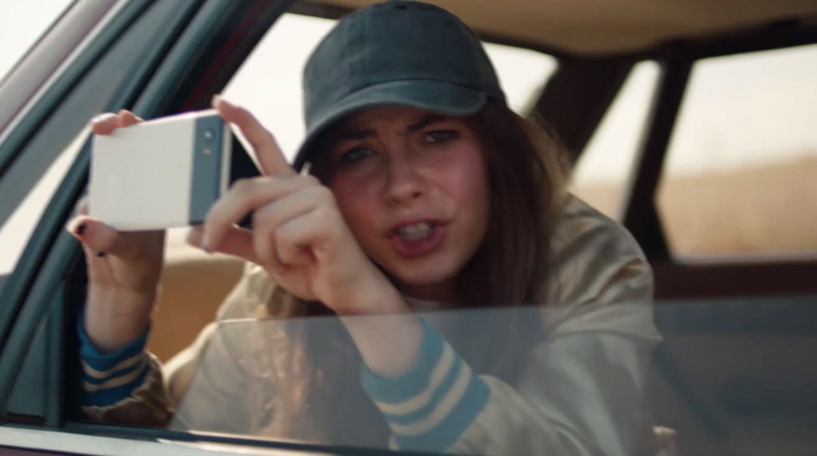 a woman taking a picture of herself in a car