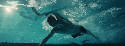 a man swimming under water in a pool