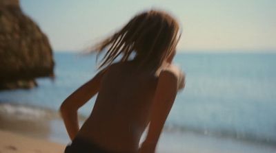 a blurry photo of a woman on the beach