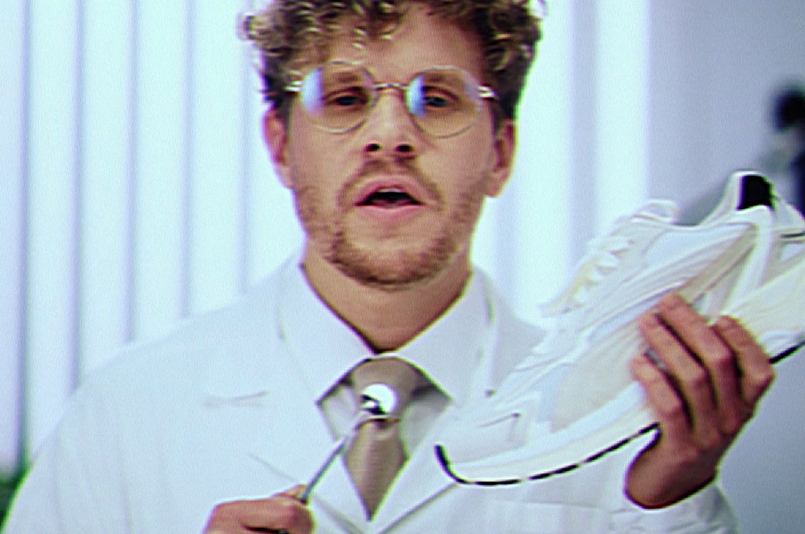 a man holding a pair of shoes in his hands