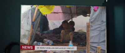 a couple of kids sitting under a tent