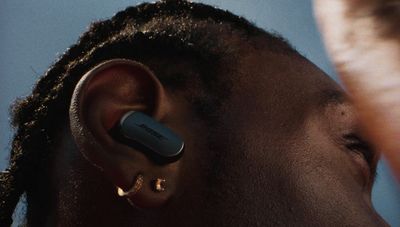 a close up of a person wearing a pair of ear buds