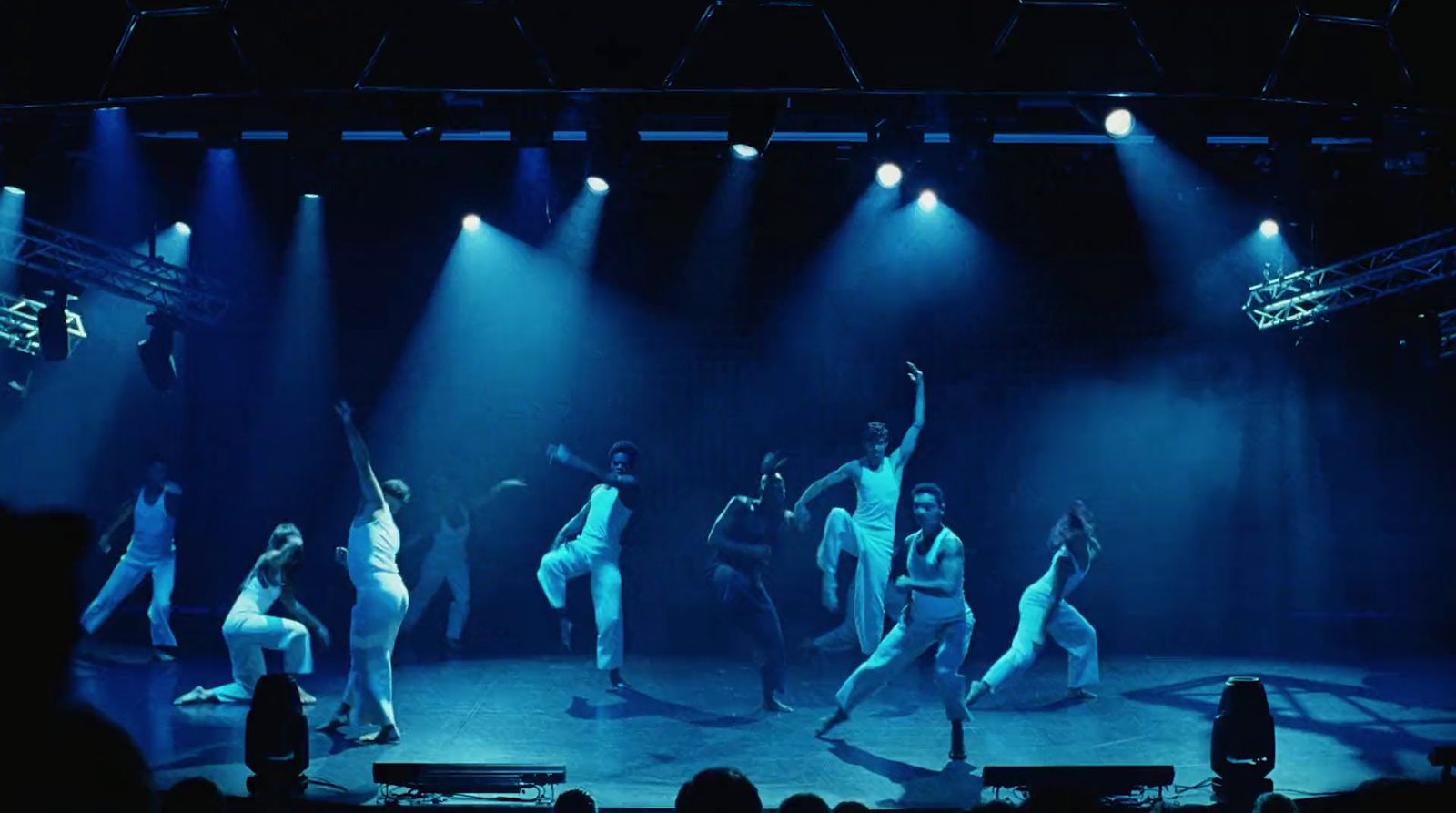 a group of people standing on top of a stage