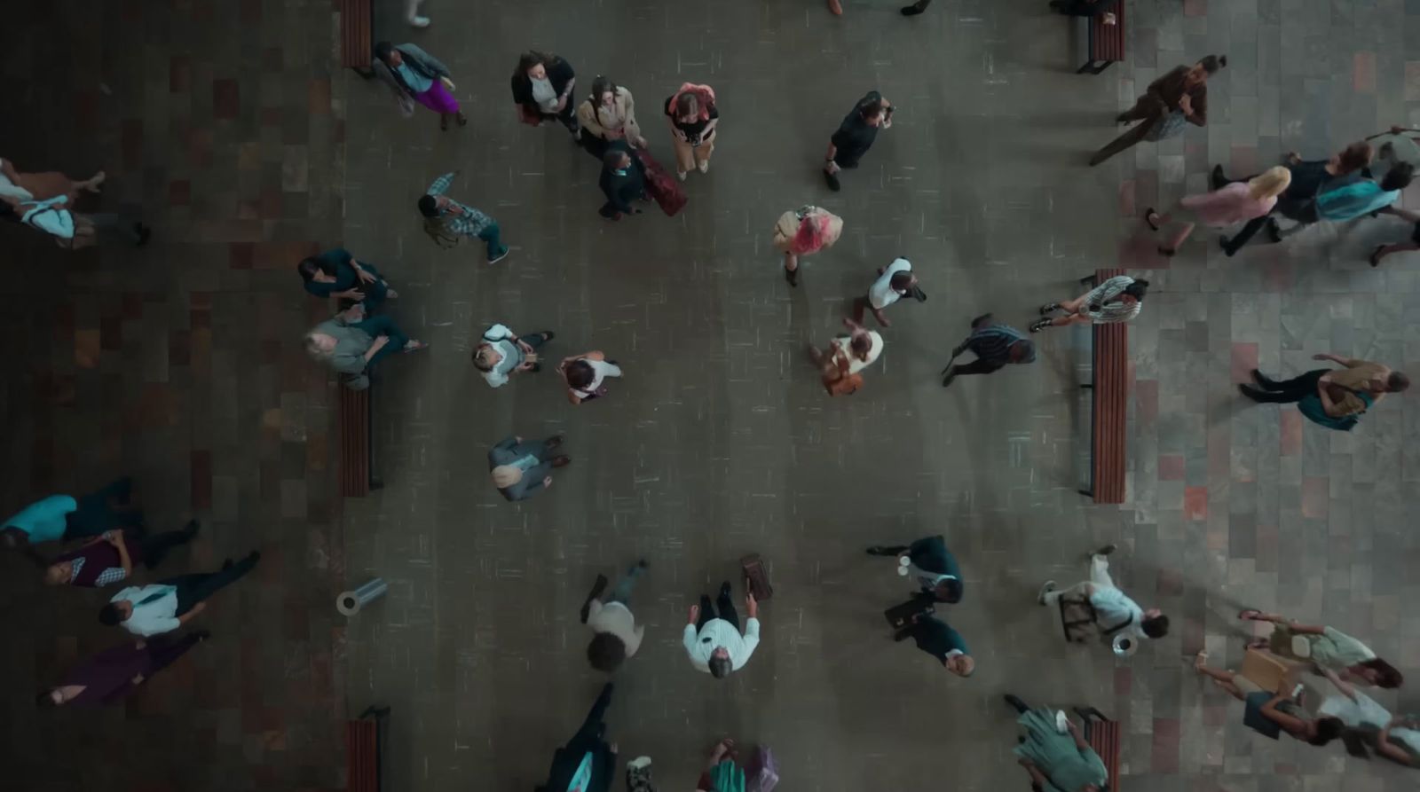 a group of people walking down a street next to each other