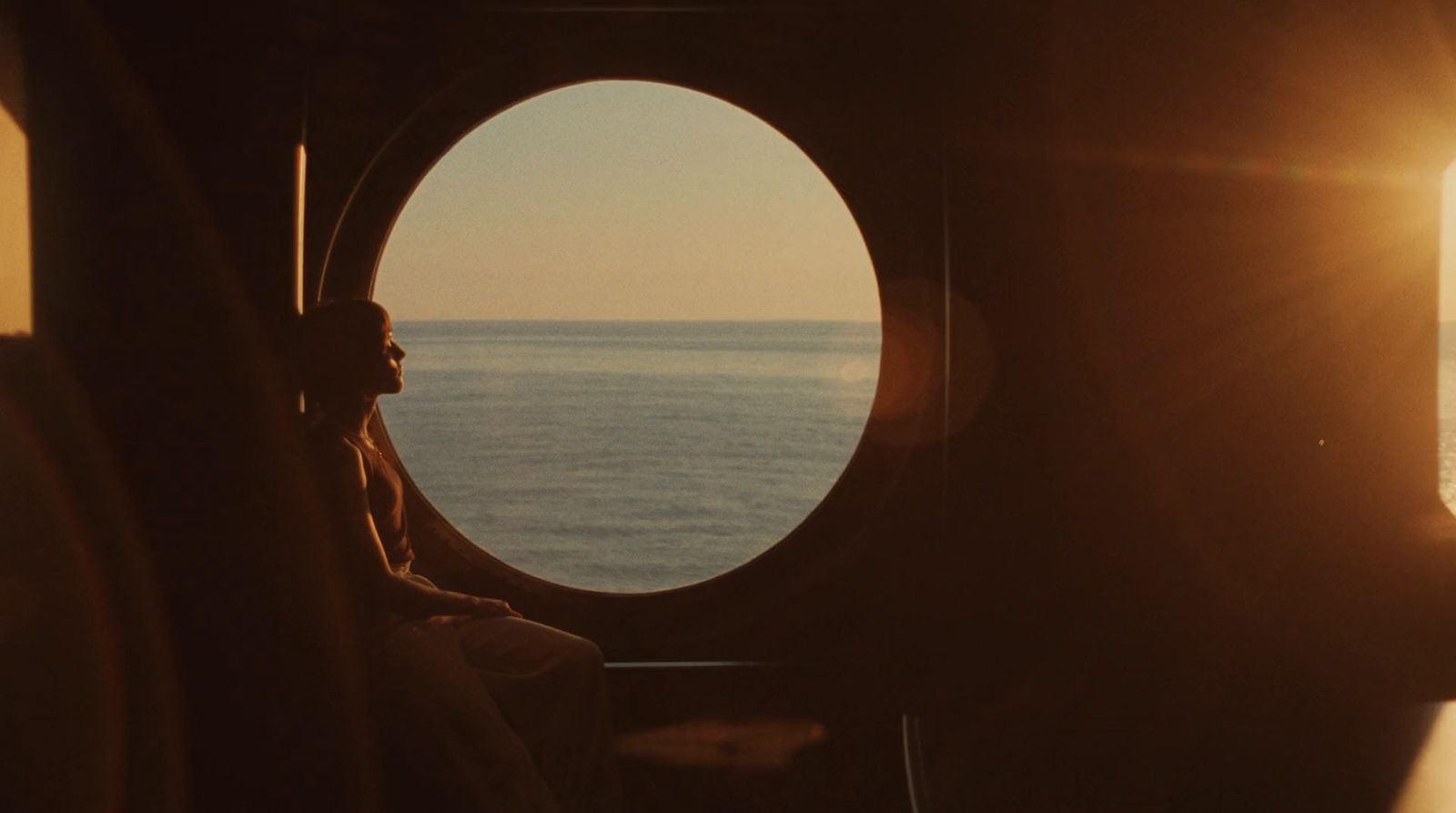 a person sitting on a boat looking out the window