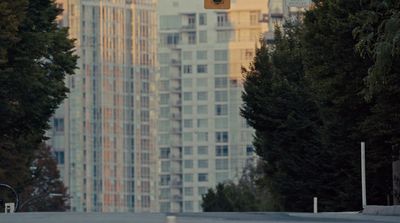 a traffic light hanging over a street next to tall buildings