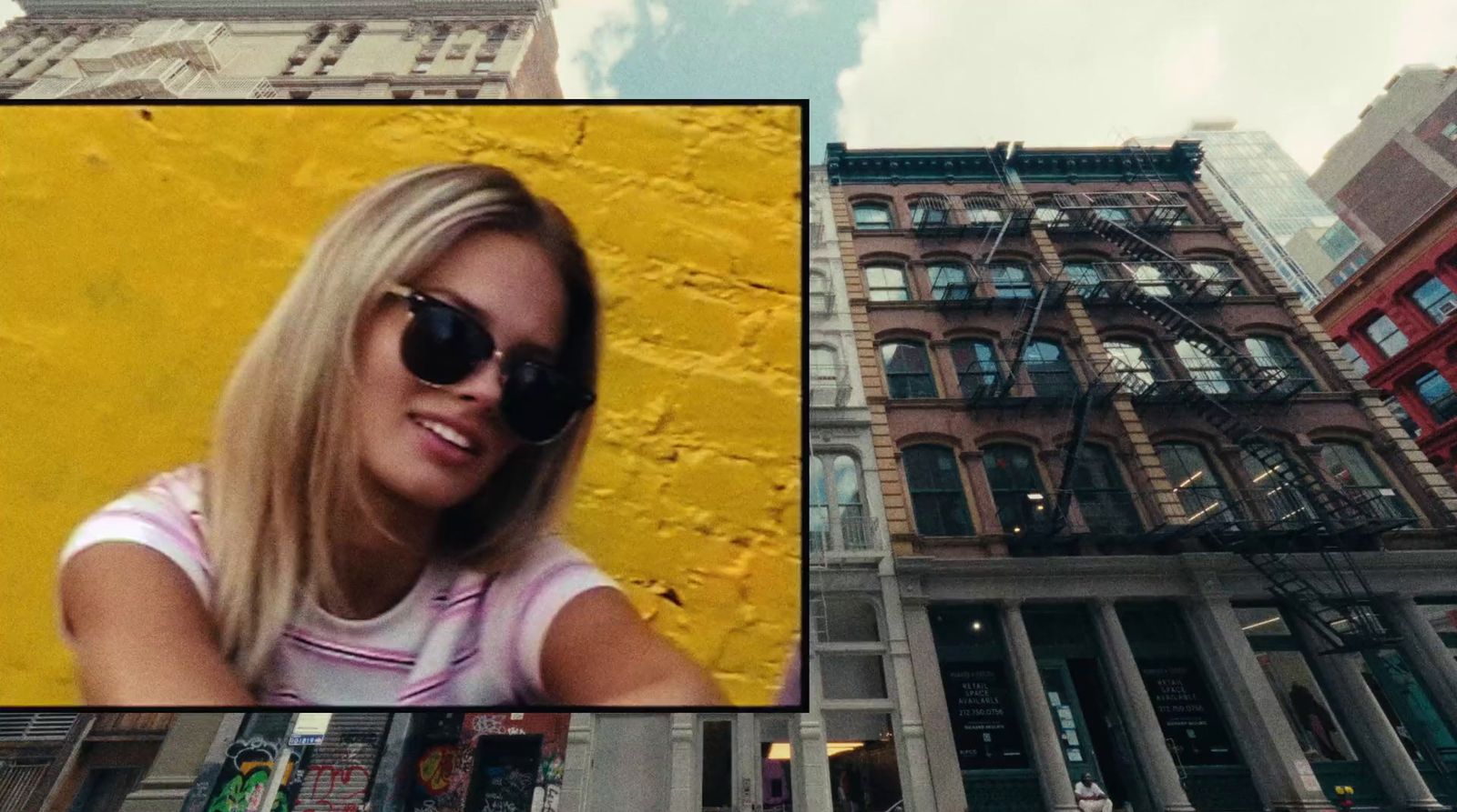 a picture of a woman wearing sunglasses in front of a building