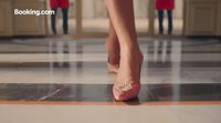 a woman's feet in high heels on a tiled floor