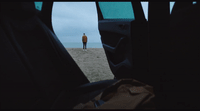 a person standing on a beach looking out at the ocean