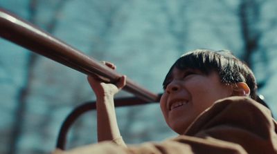 a young woman is smiling while holding onto a rail