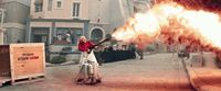 a woman holding a gun in front of a fire