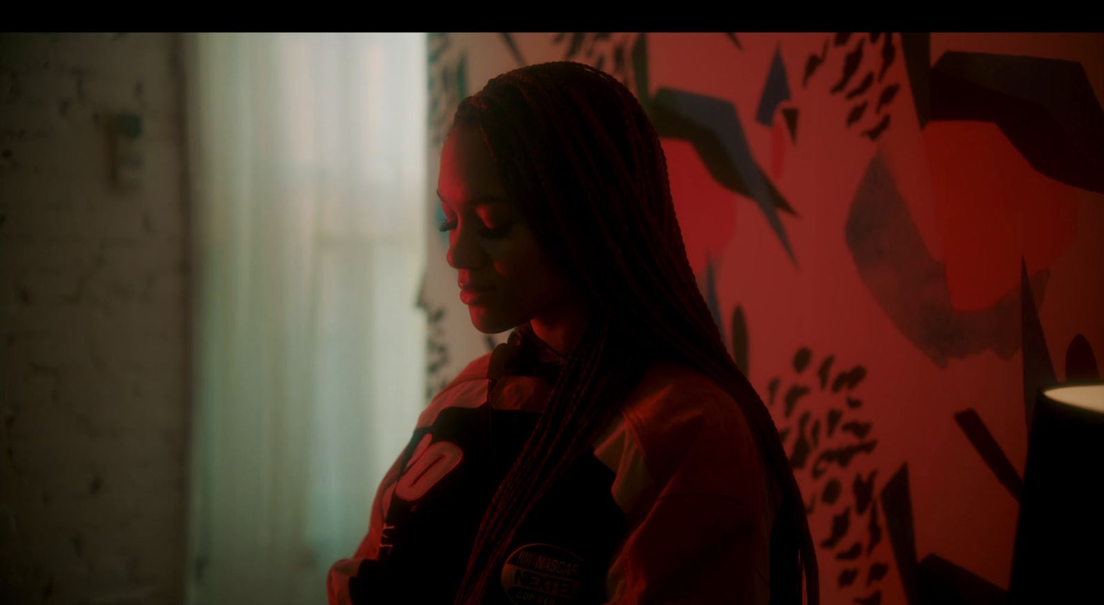 a woman standing in front of a red wall