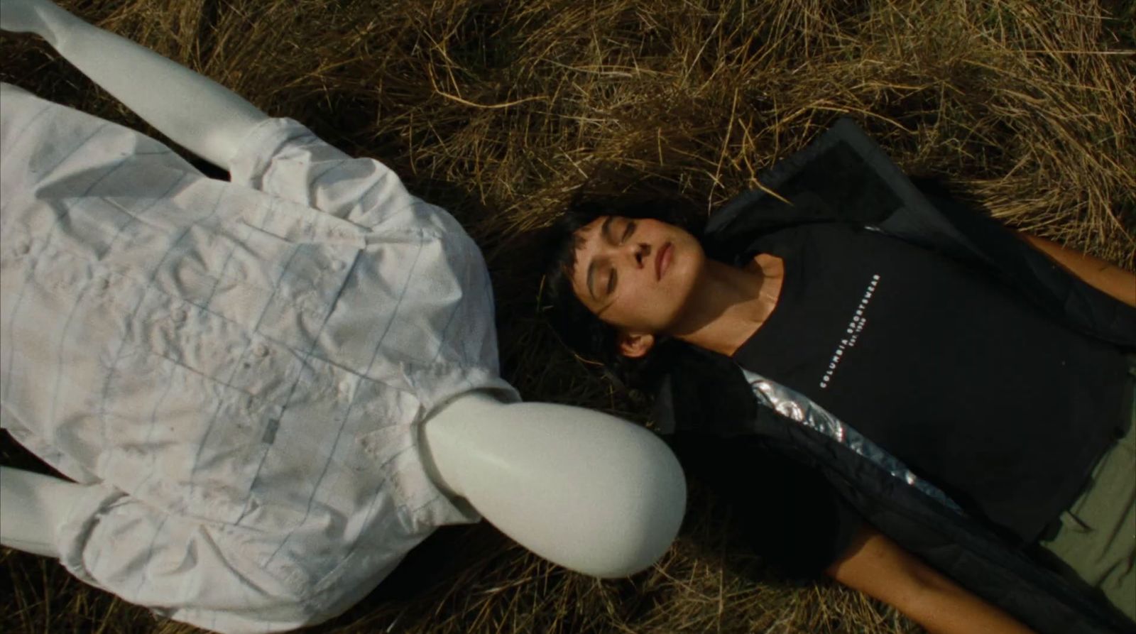 a man laying on the ground next to a white frisbee