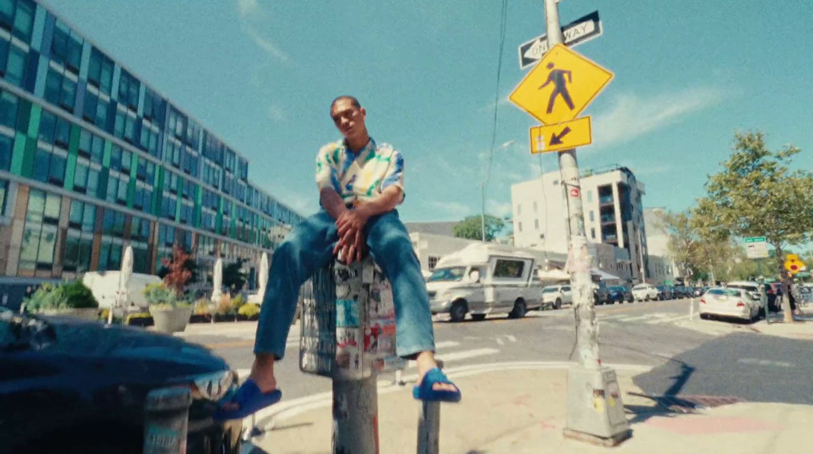 a man sitting on top of a parking meter