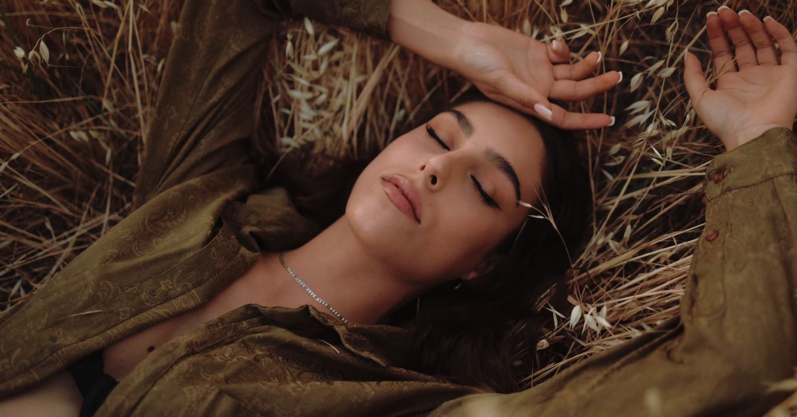 a woman laying on the ground with her eyes closed