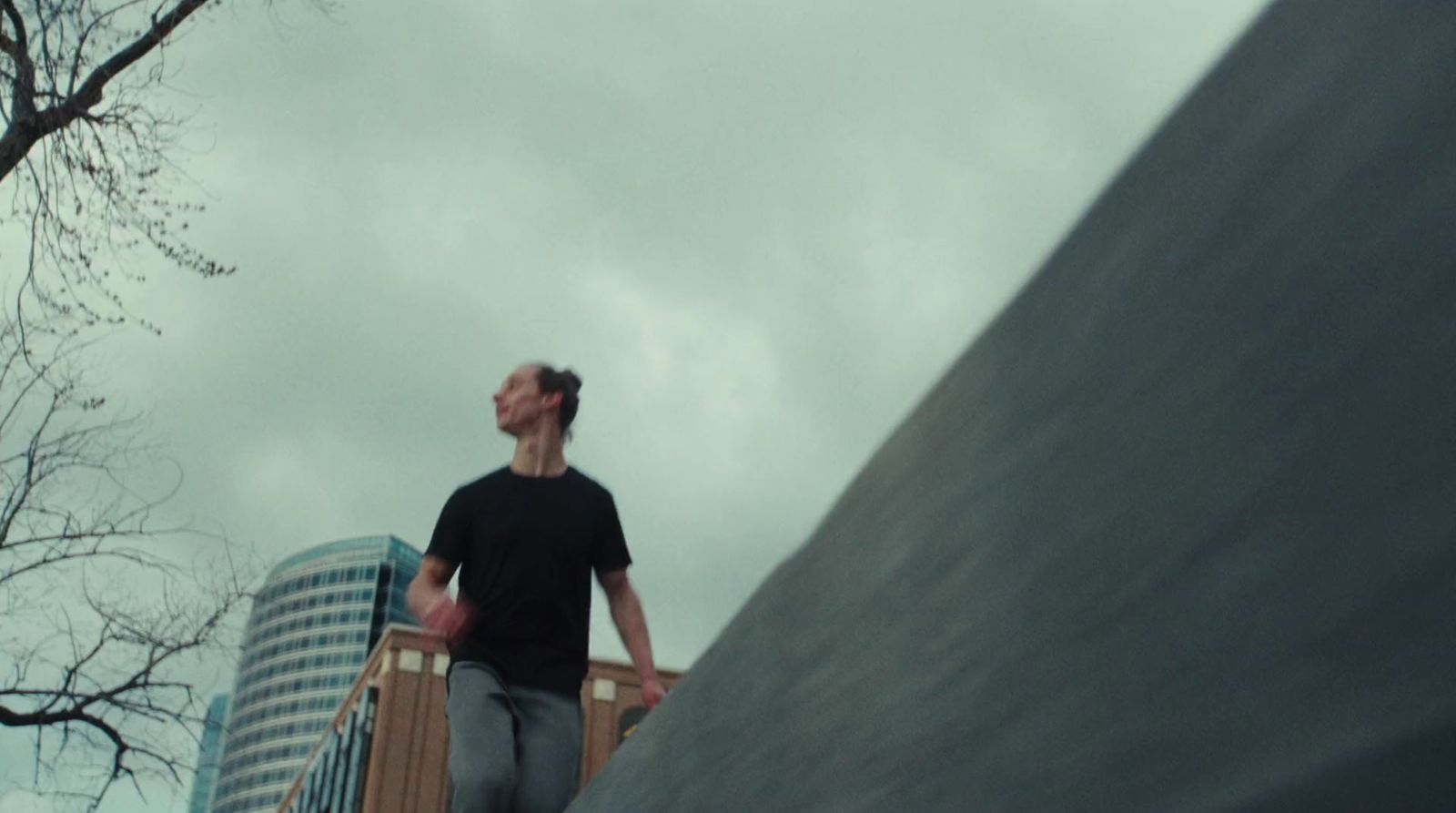 a man walking up a ramp with a skateboard