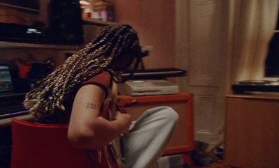 a person with dreadlocks sitting in a room