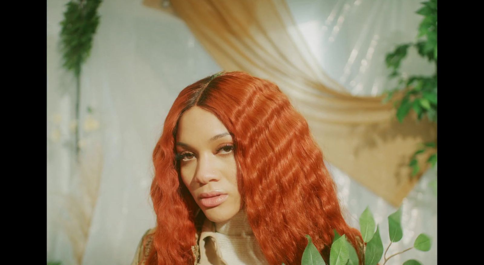 a woman with long red hair is posing for a picture