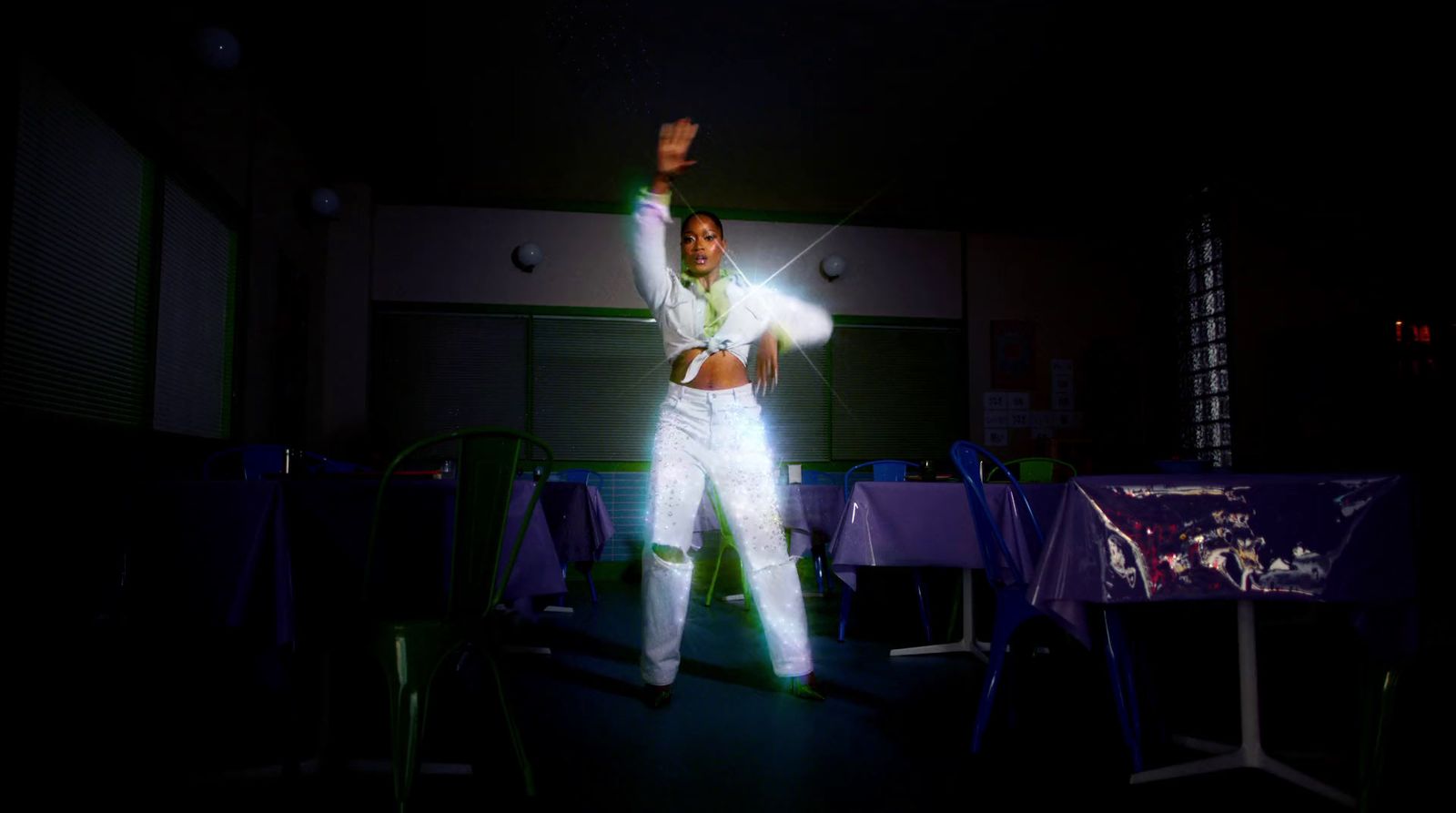 a man standing on a stage with his arms in the air