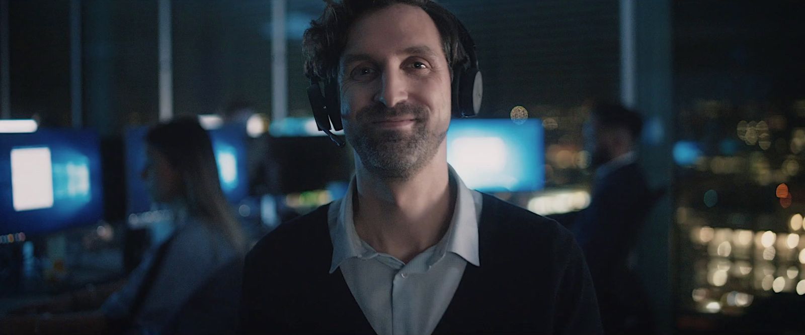 a man wearing headphones in a dark room