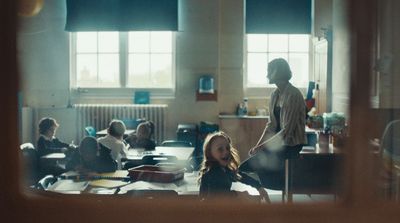 a group of people sitting around a table in a room