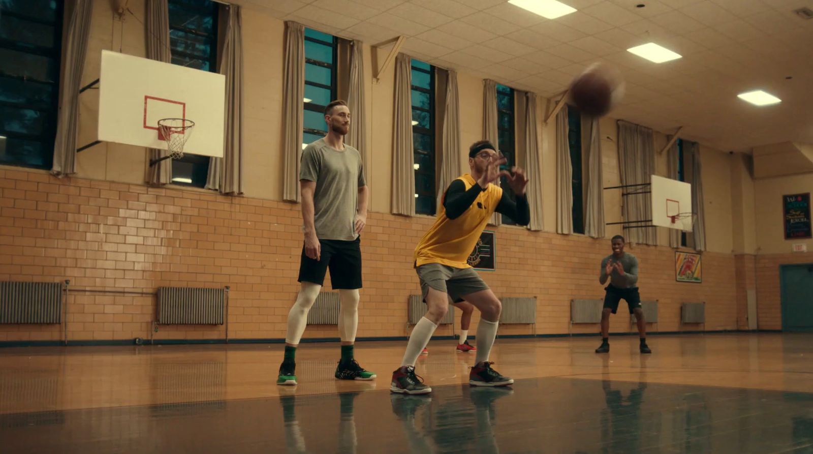 a group of young men playing a game of basketball