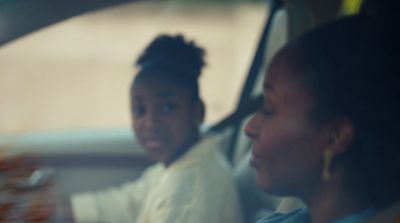 a man and a woman sitting in a car