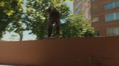 a man riding a skateboard down the side of a wall