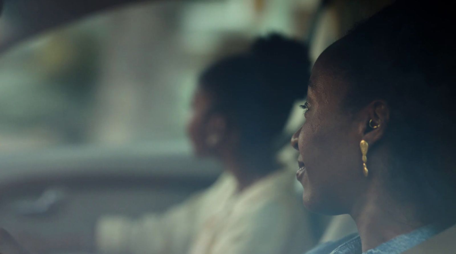 a woman sitting in the passenger seat of a car