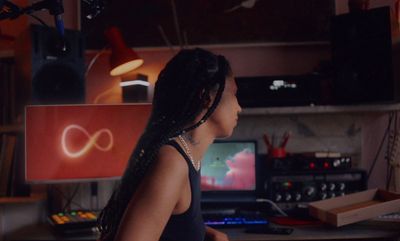 a woman sitting in front of a computer desk