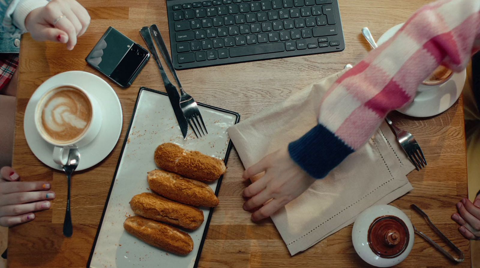 a table topped with donuts and a cup of coffee