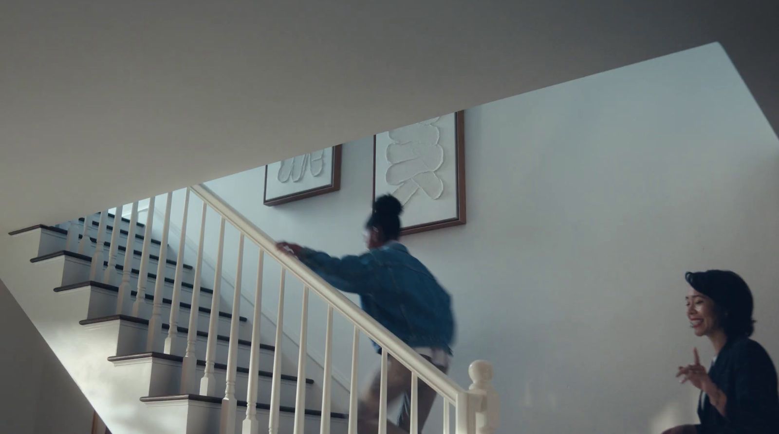 a man and a woman walking up a stair case