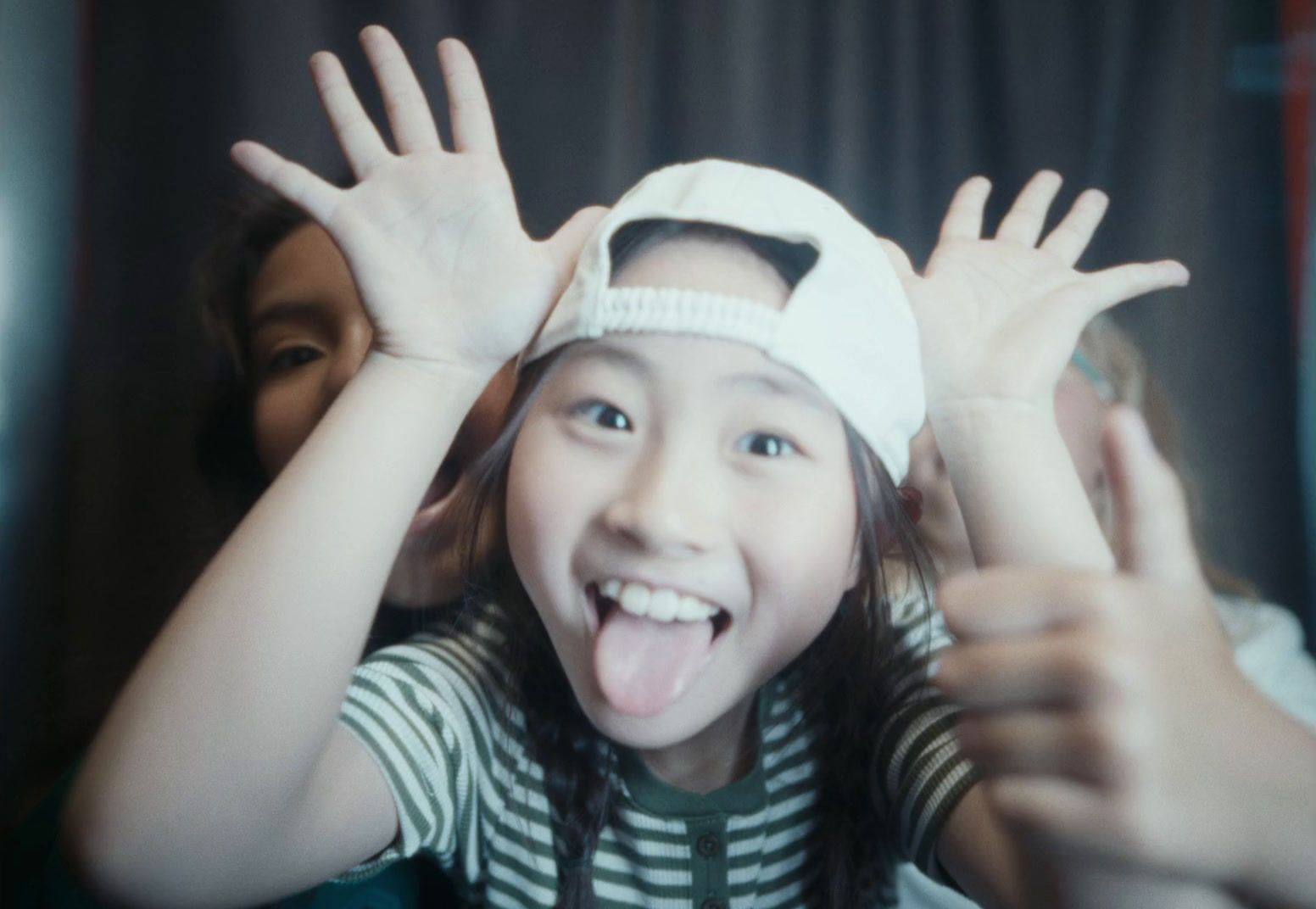 a young girl with her hands in the air