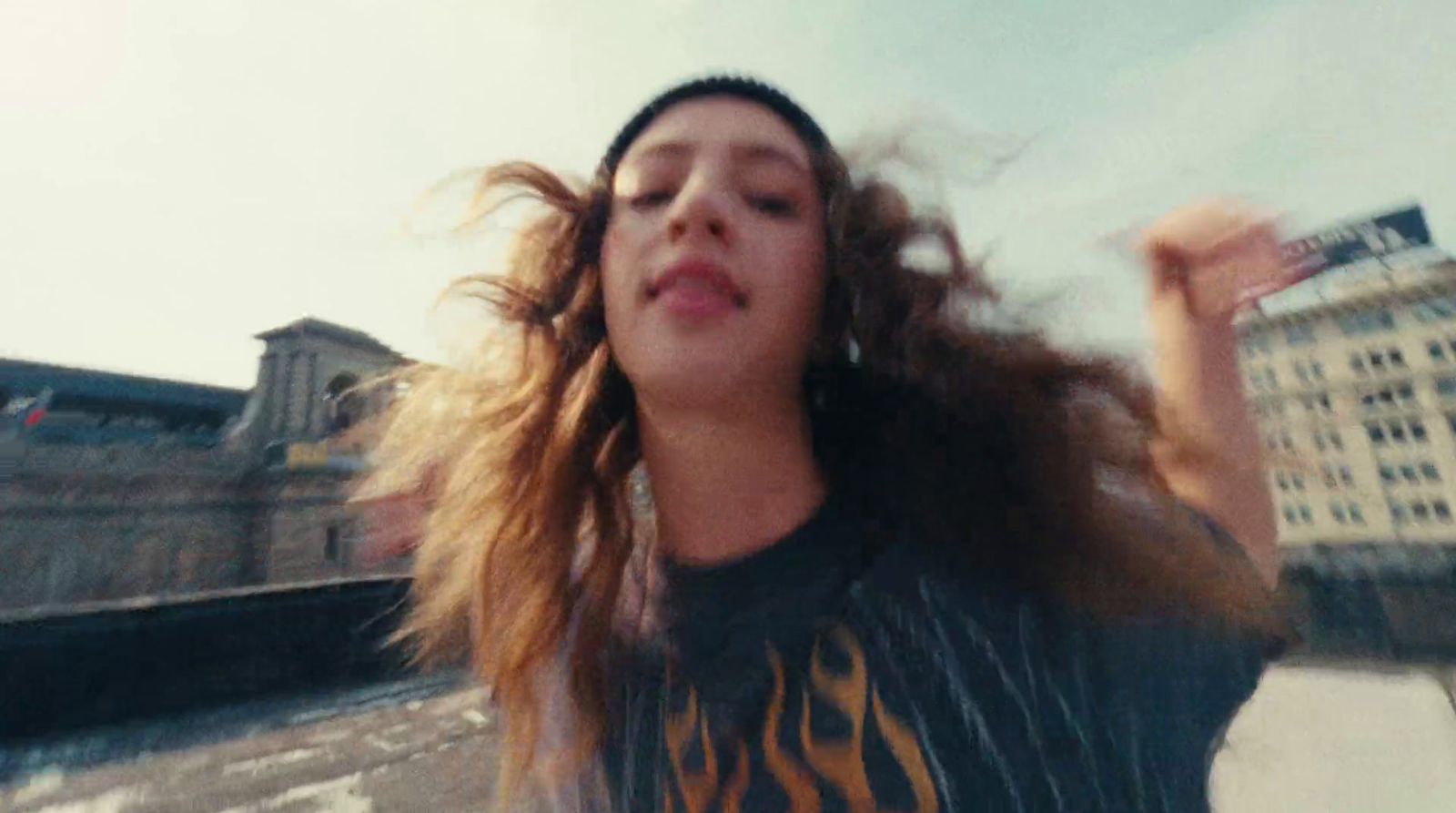 a woman with her hair blowing in the wind