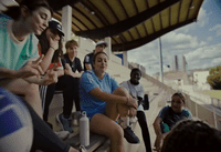 a group of people sitting on top of a bench