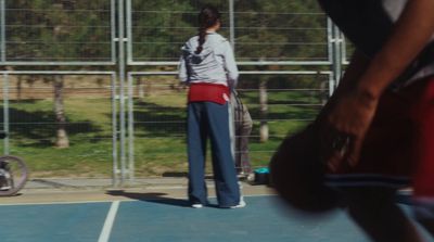 a man standing on a tennis court holding a tennis racquet