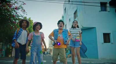 a group of young children standing on the side of a road